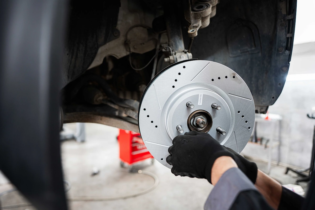 mechanic-installing-new-brake-disc-on-a-vehicle-2025-02-11-15-27-43-utc